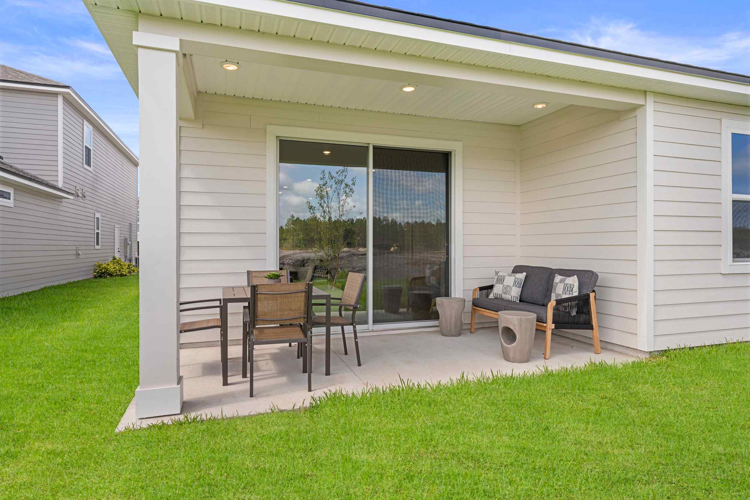 Laurel II Model Home Covered Patio with Table and Chairs at Camden Woods in Kingsland, GA