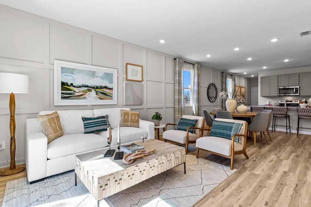 A living room with a large rug and a couch.
