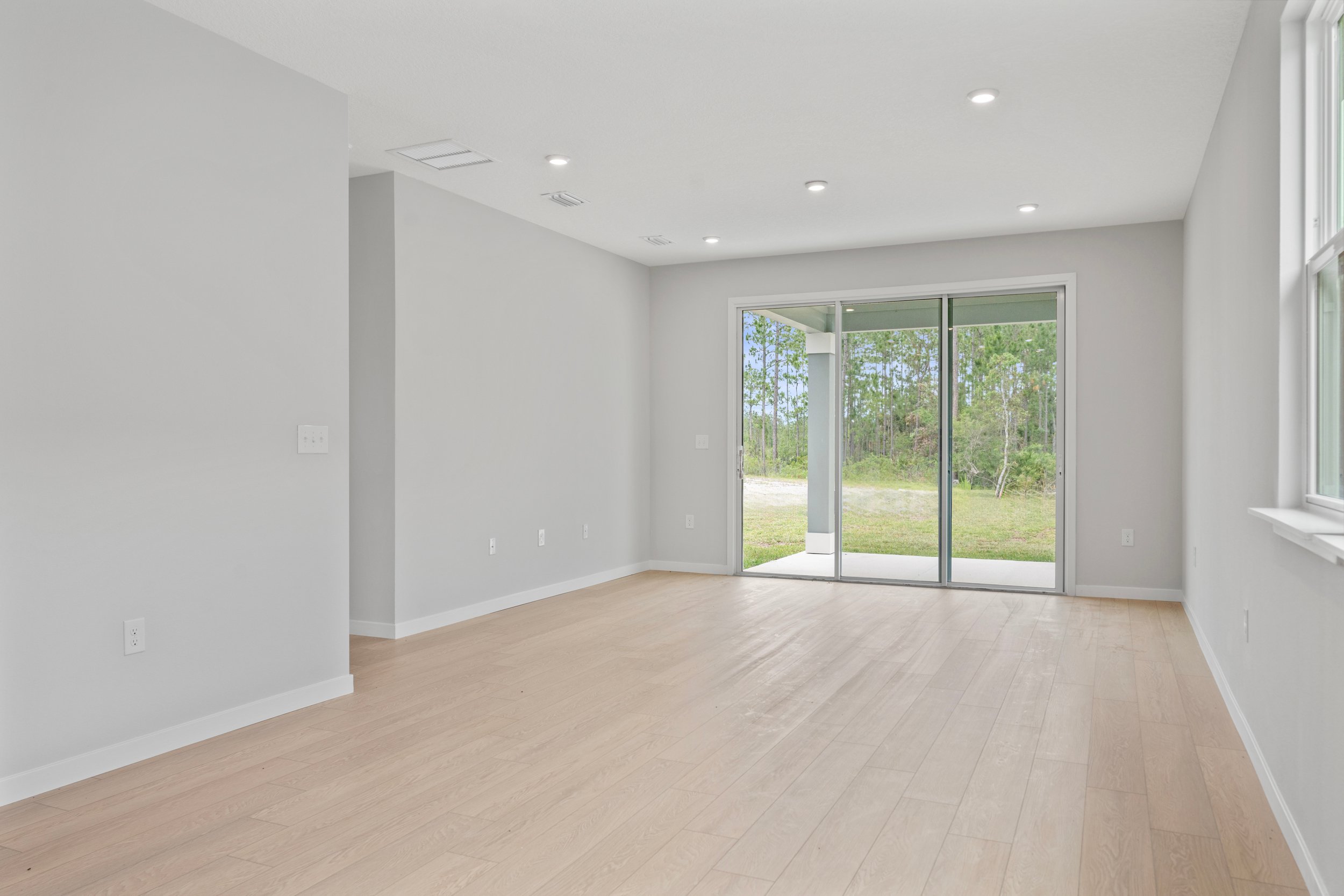 Sanibel II Floorplan Lot 72 Great Room with Triple Slider Patio Door at Seminole Palms in Palm Coast