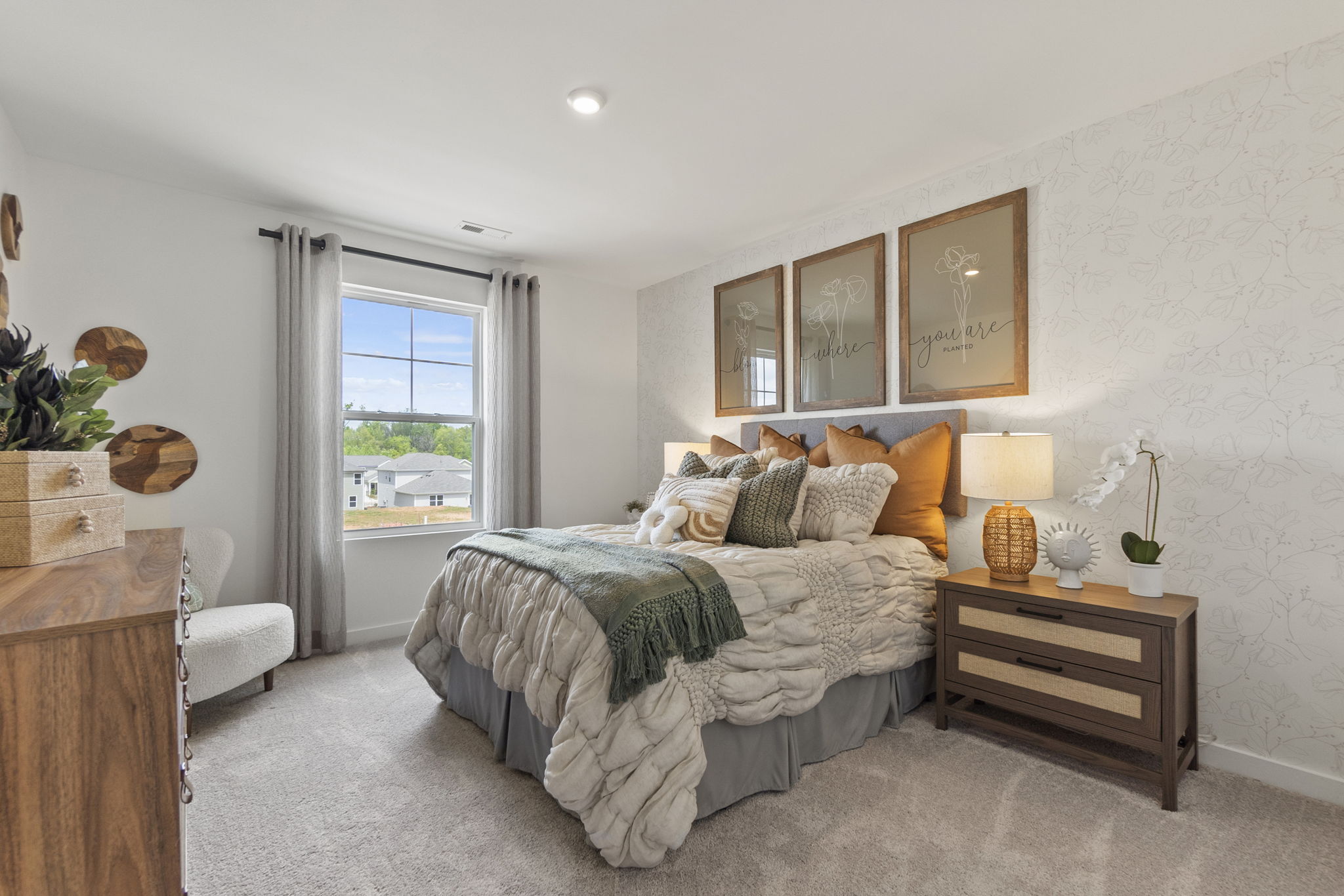 A bedroom with a bed and a table.