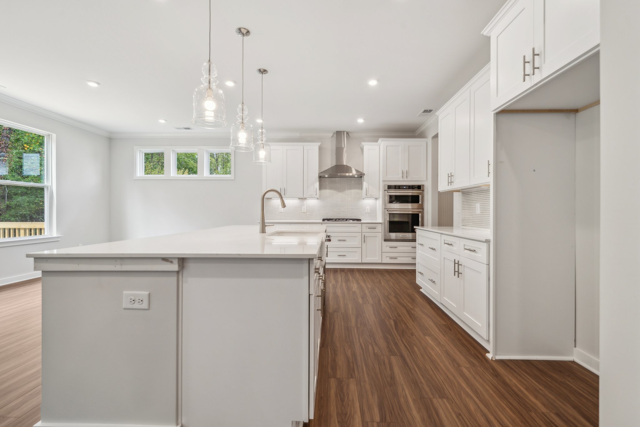 A kitchen with white cabinets.