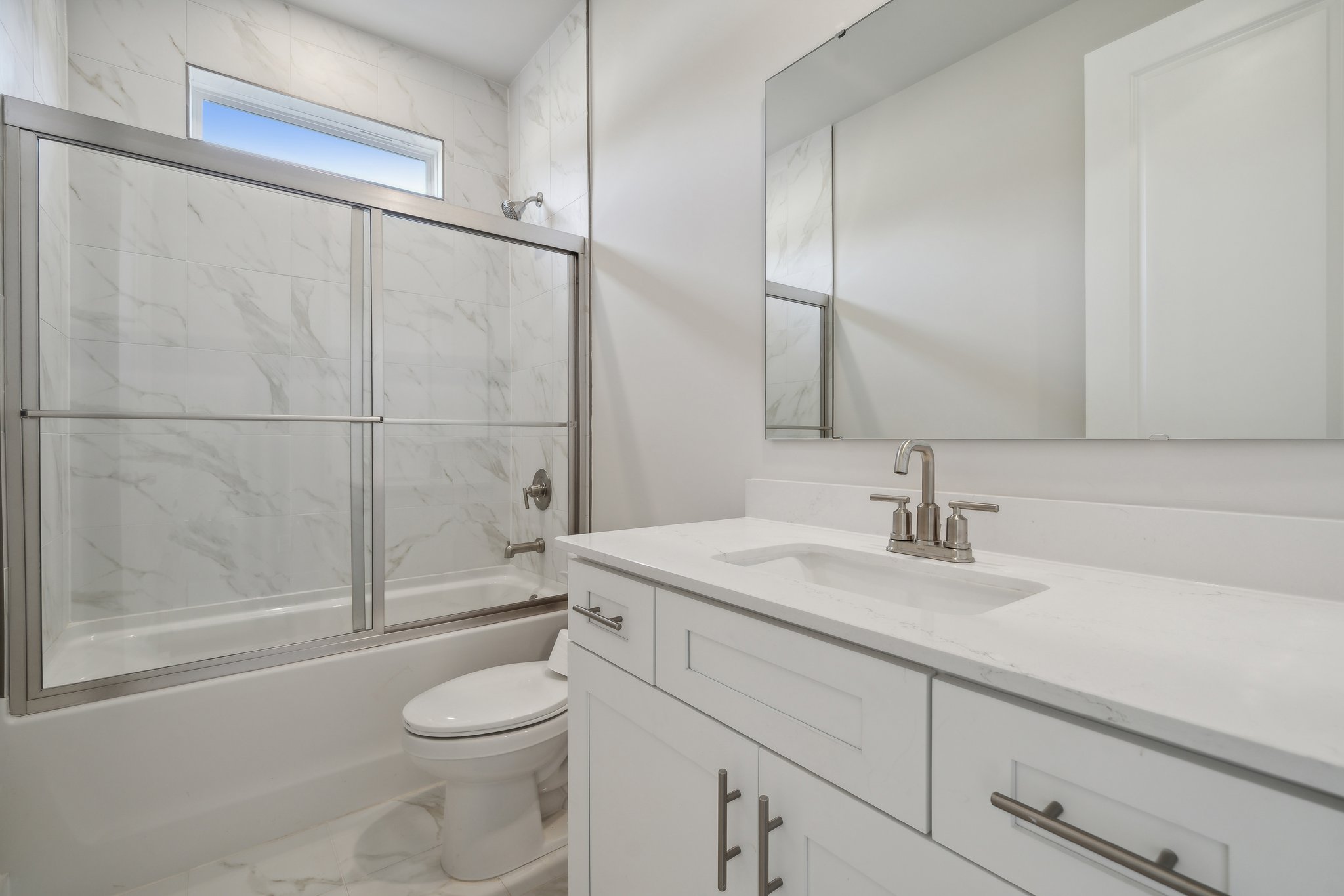 A bathroom with a glass shower.