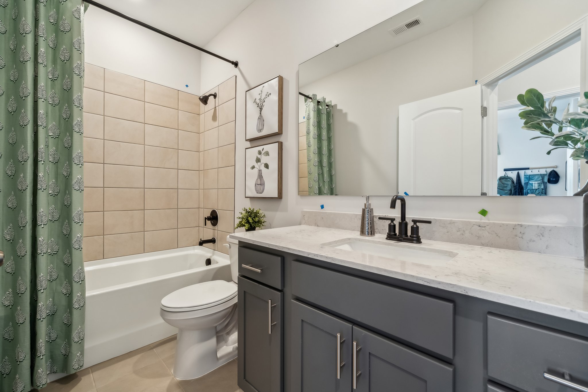 A bathroom with a tub sink and toilet.