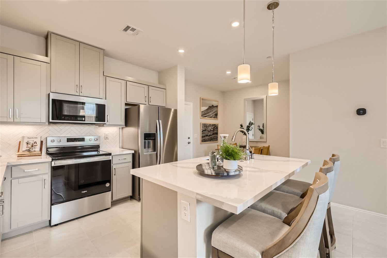 A kitchen with white cabinets.