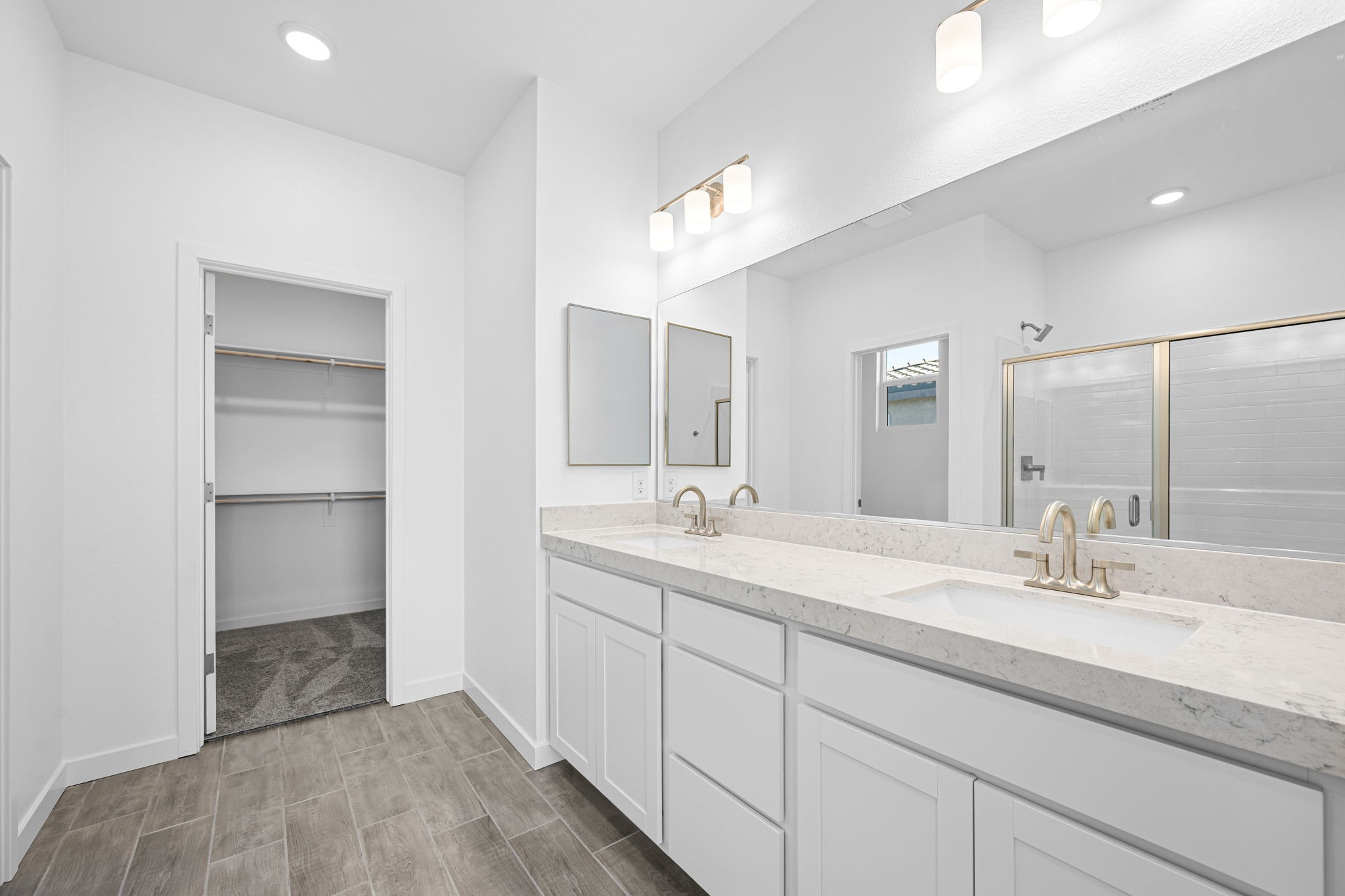 A bathroom with a large mirror.