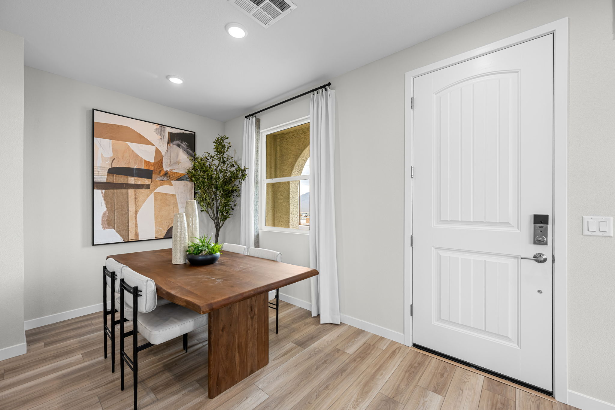 A room with a table and chairs.