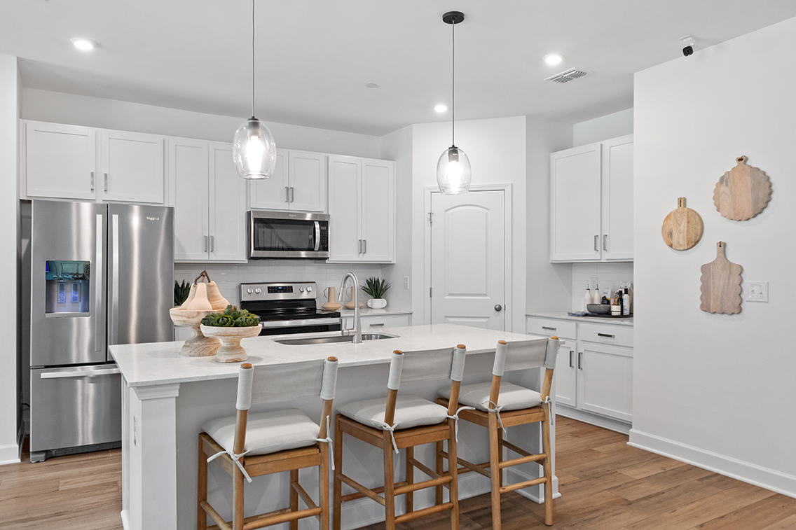 A kitchen with white cabinets.