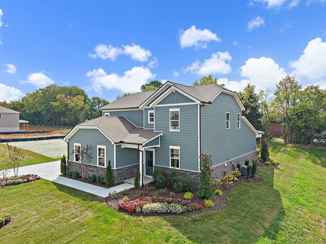 A house with a garden in the front.