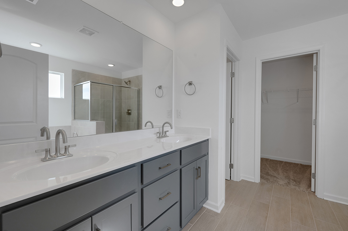 A bathroom with a large mirror.