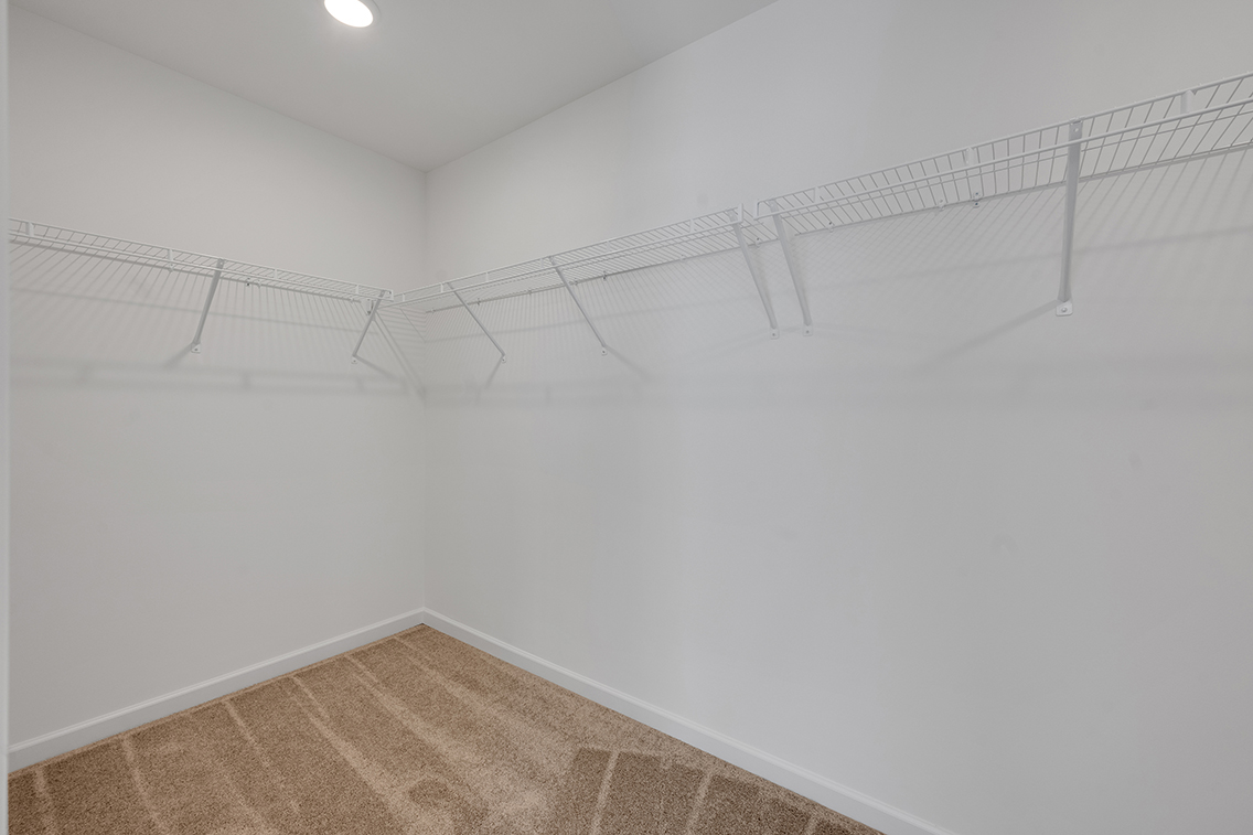 A white wall with a metal railing.