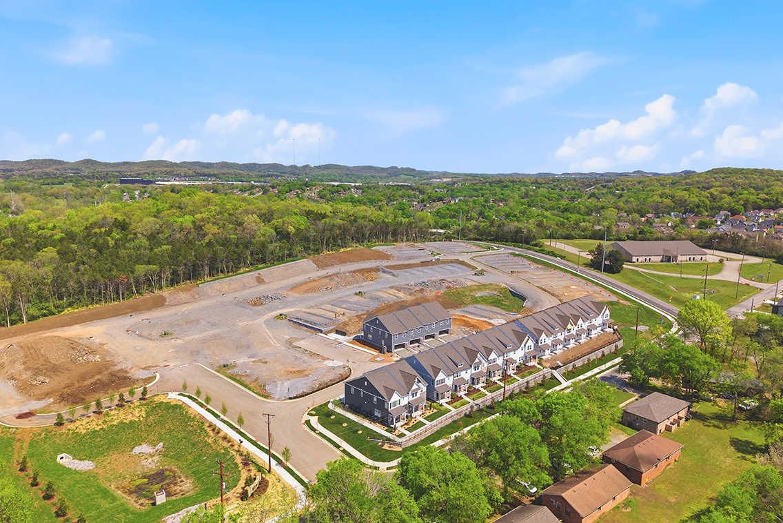 A large building with a lot of windows surrounded by trees.