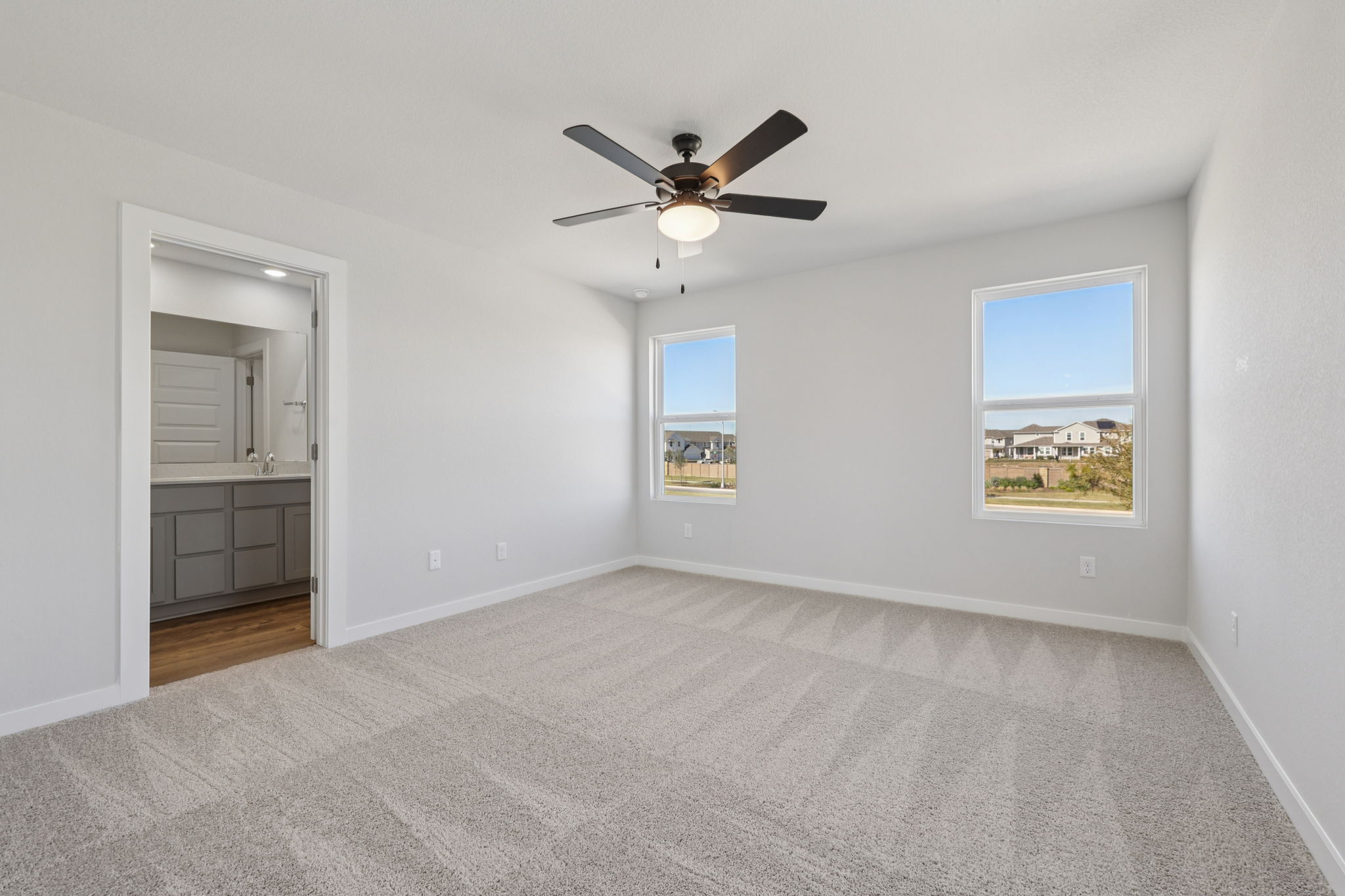 A room with a ceiling fan and a window.