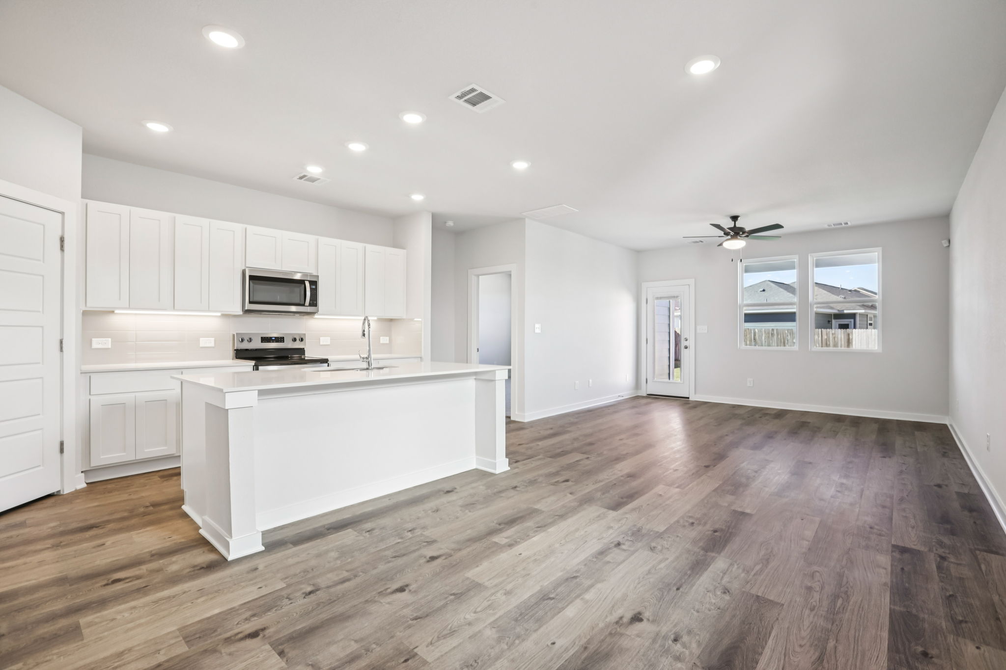 A kitchen with white cabinets.