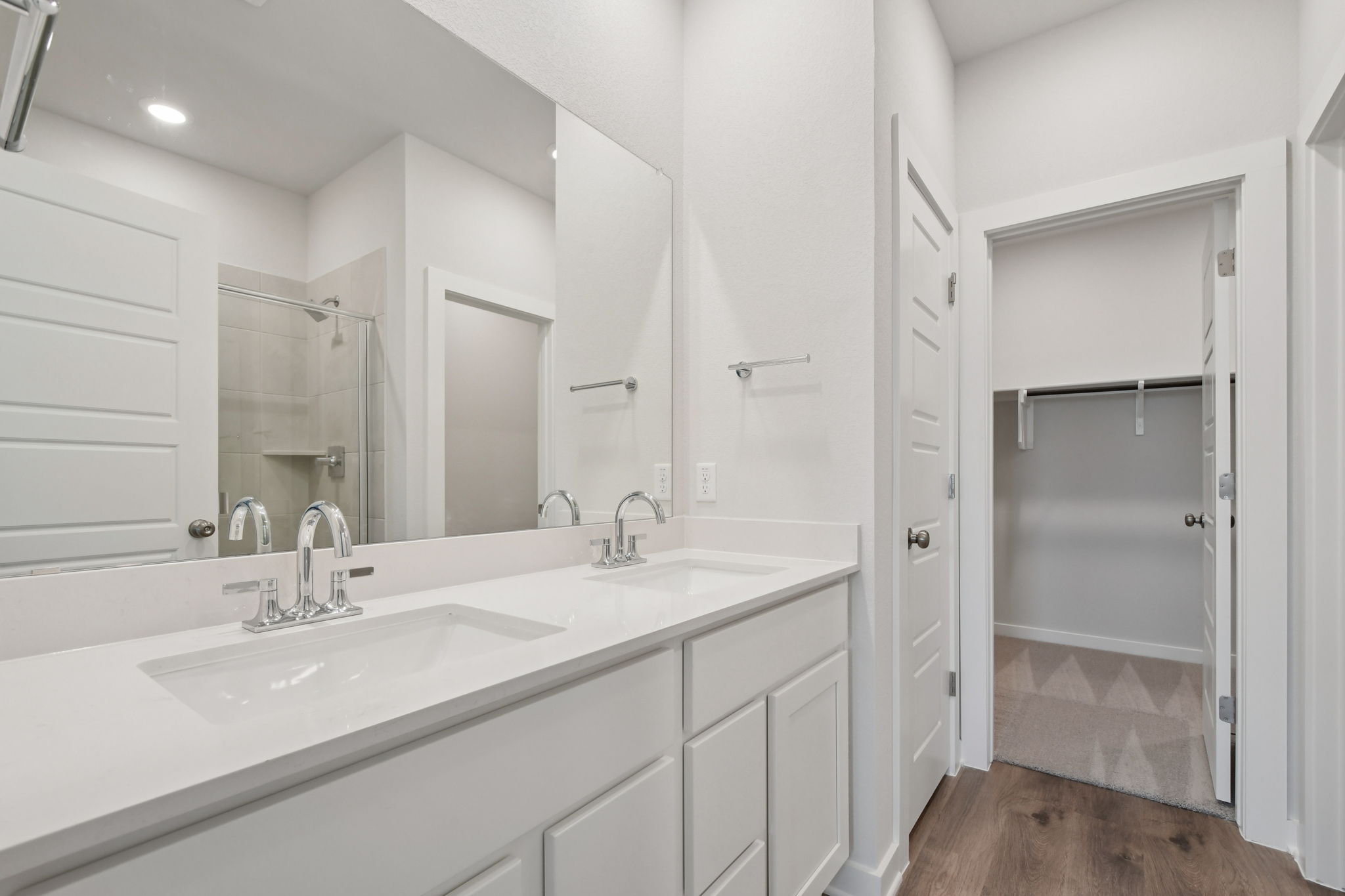 A bathroom with a sink and a shower unit.