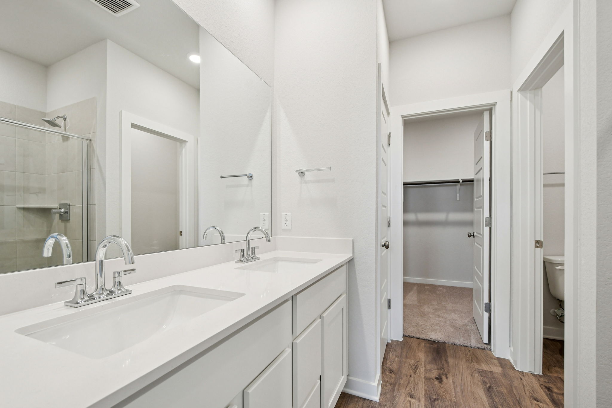 A bathroom with a sink and a shower.