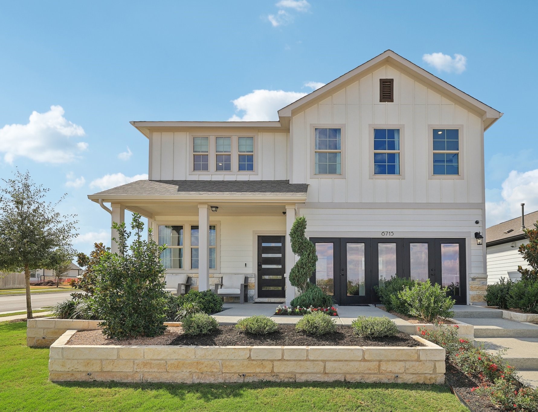 A white house with a green lawn.