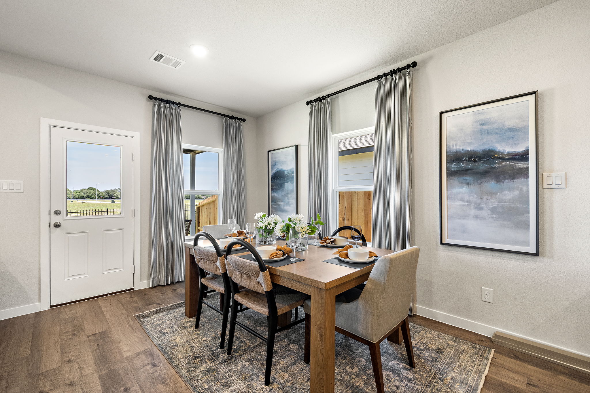 A dining room table with chairs.