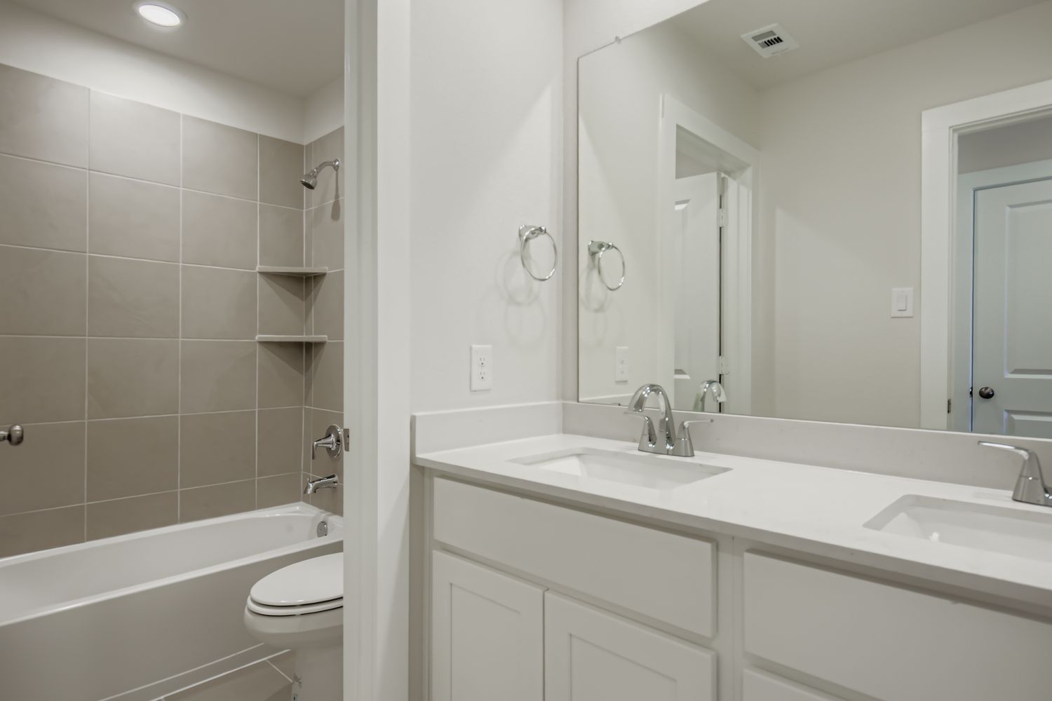 A bathroom with a tub sink and toilet.