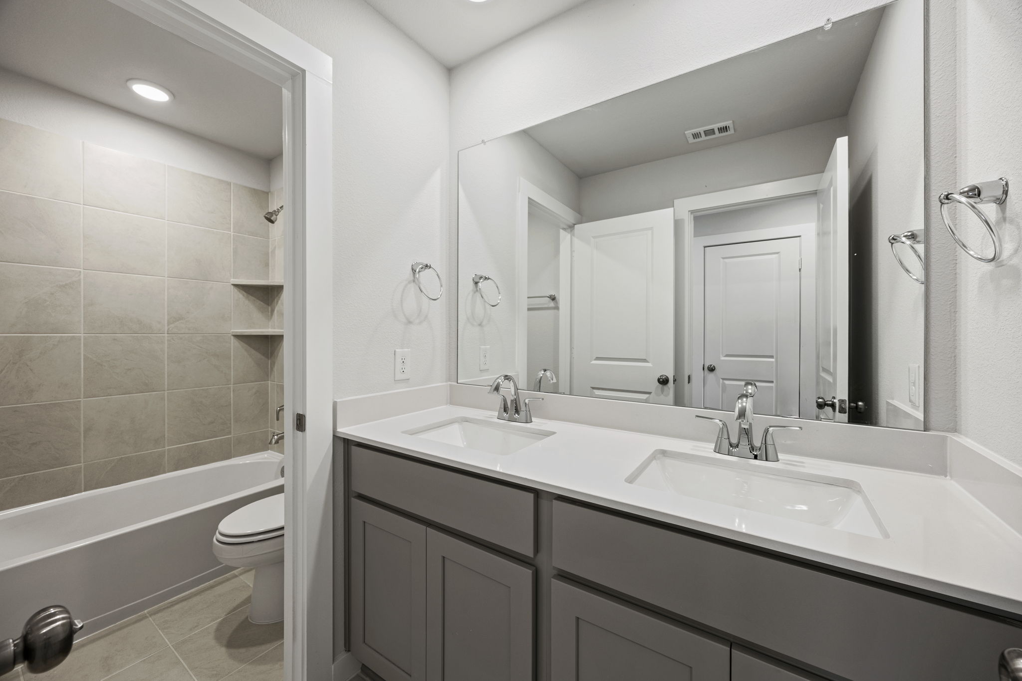 A bathroom with a tub sink and toilet.