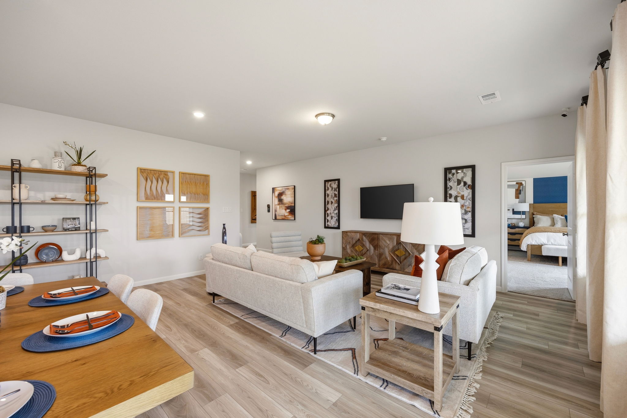 A living room with a large white couch and a table.