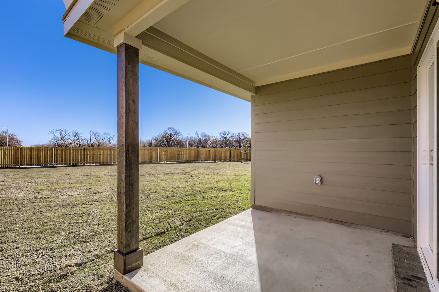 A house with a fence and grass.