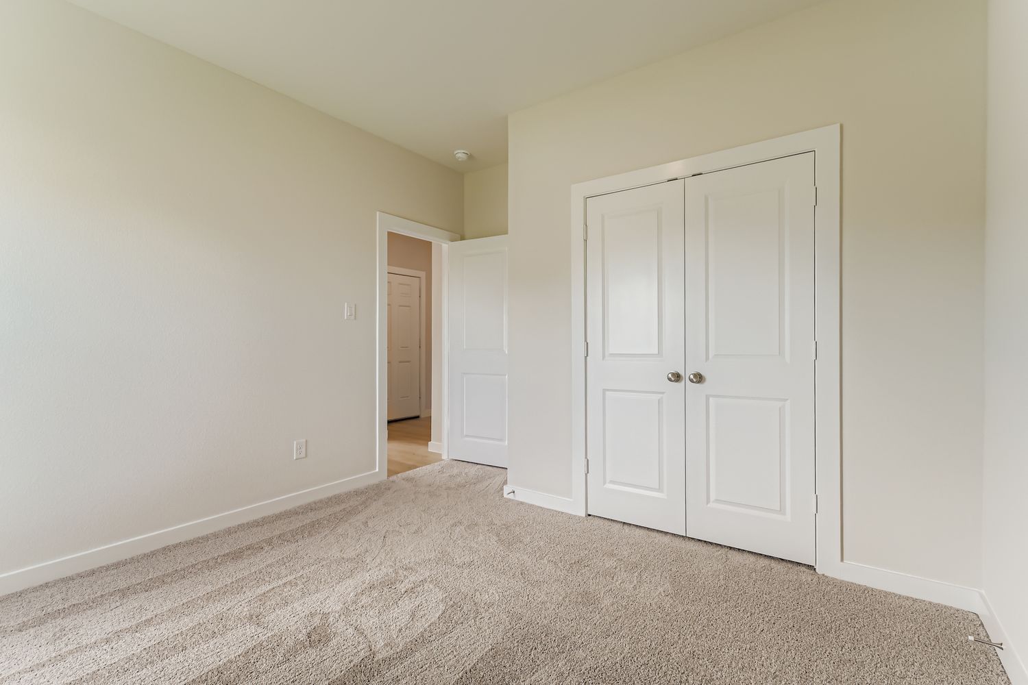 A hallway with white doors.