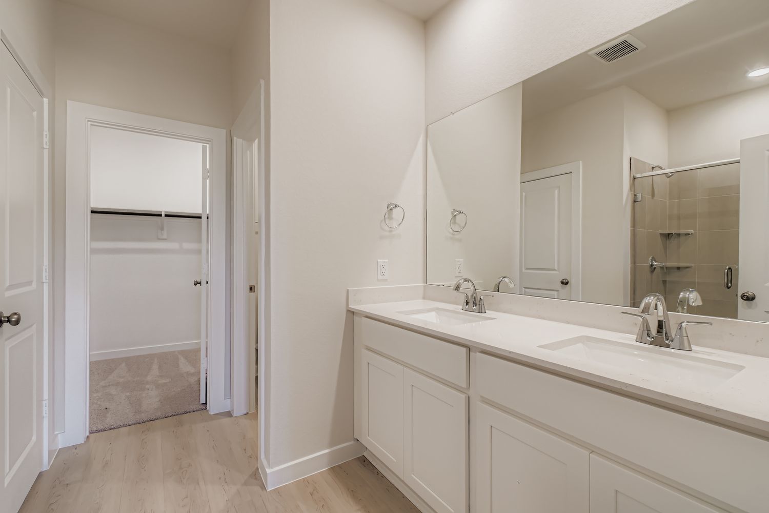 A bathroom with a large mirror.