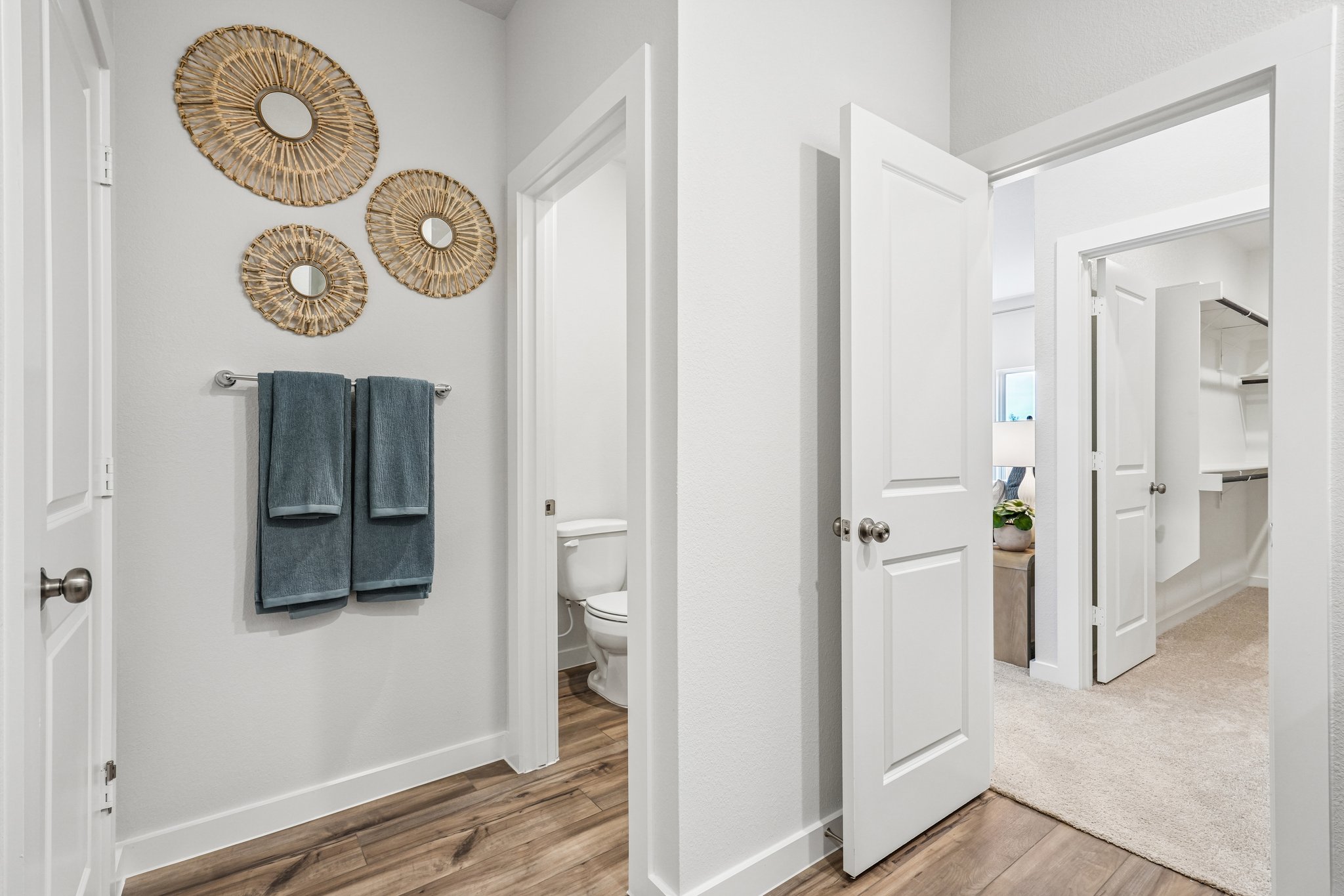 A bathroom with a toilet and a mirror.