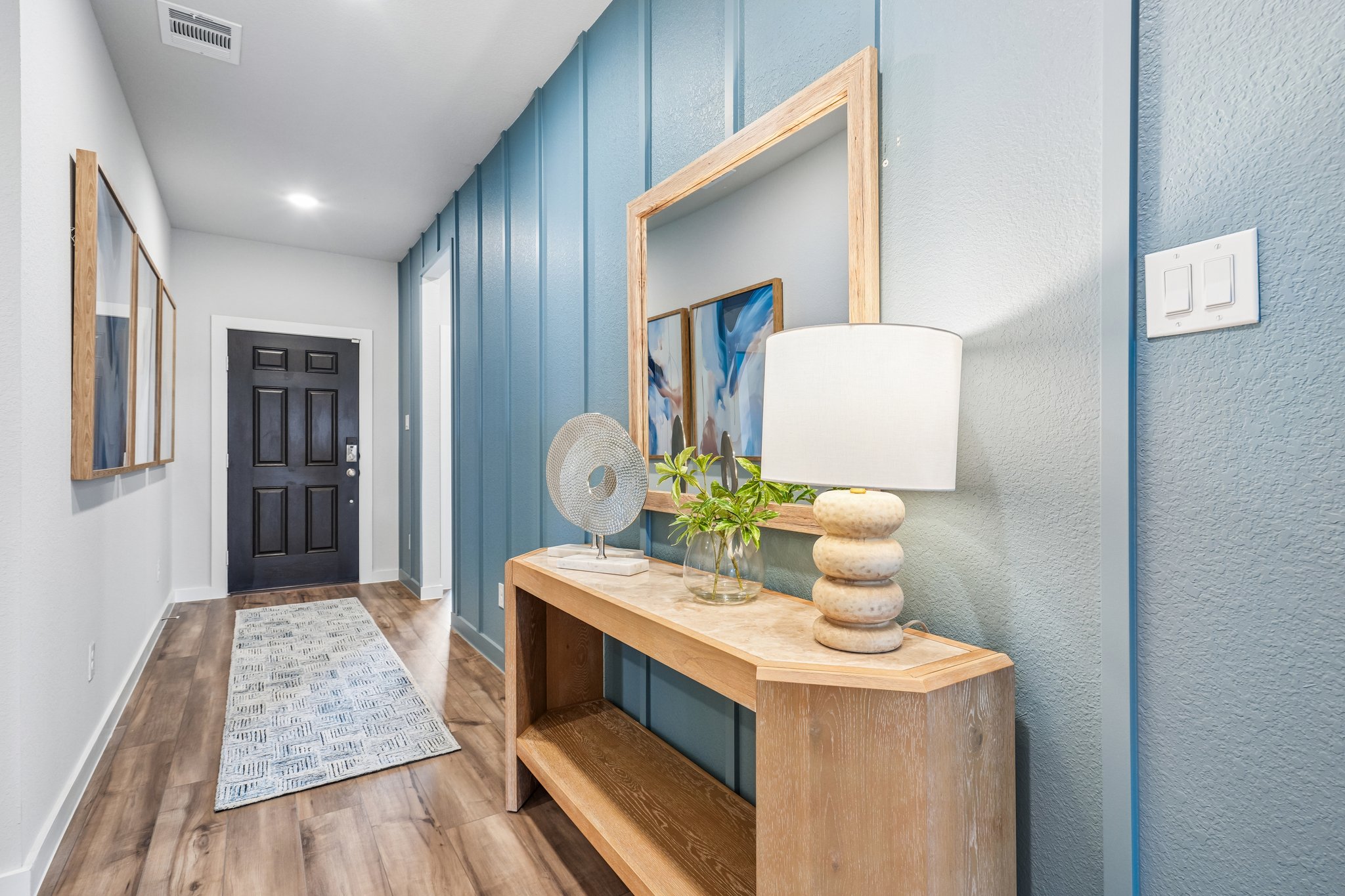 A room with a table and a mirror.