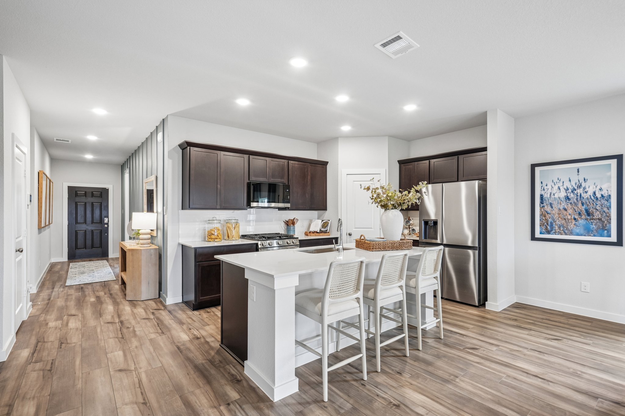 A kitchen with a wood floor.