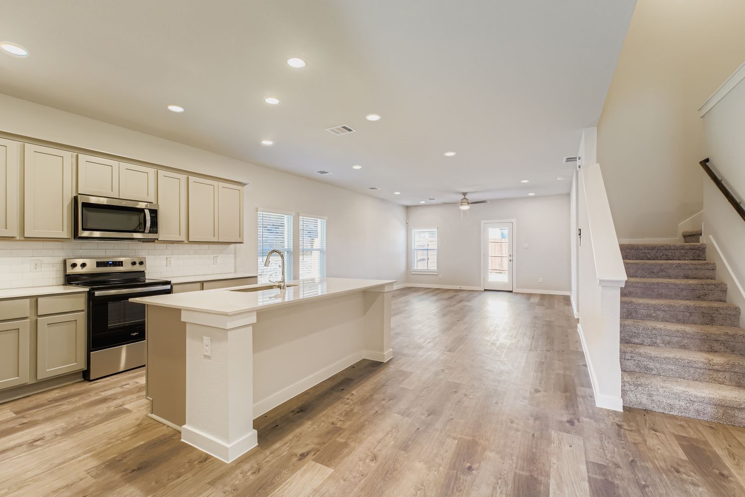 A kitchen with white cabinets.