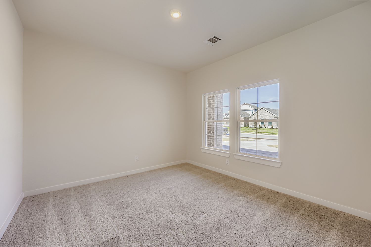 A room with a window and a carpet.