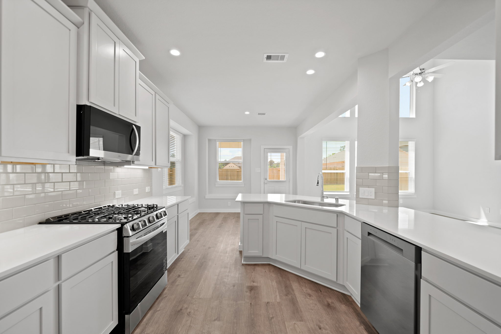 A kitchen with white cabinets.