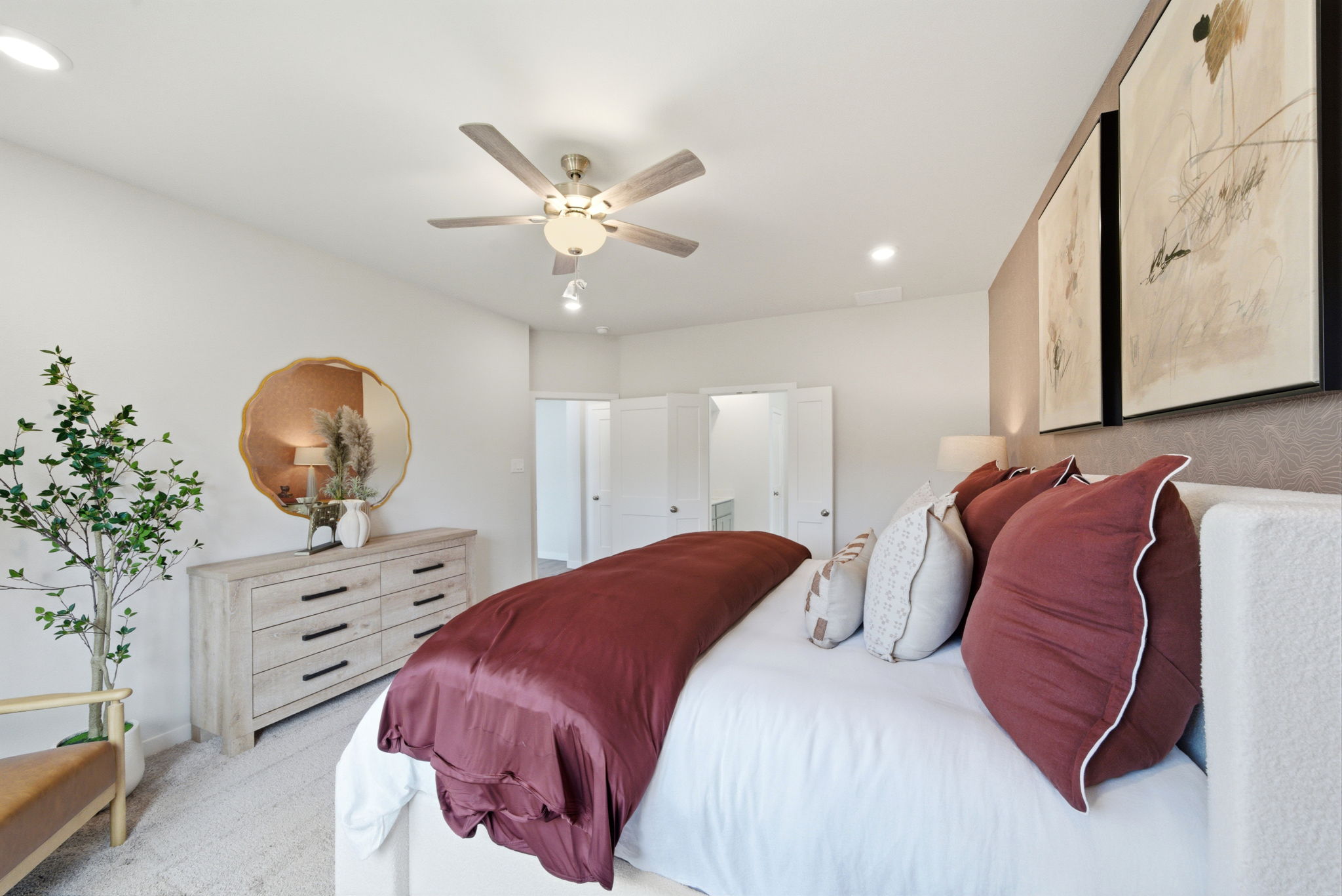 A bedroom with a bed and a fan.