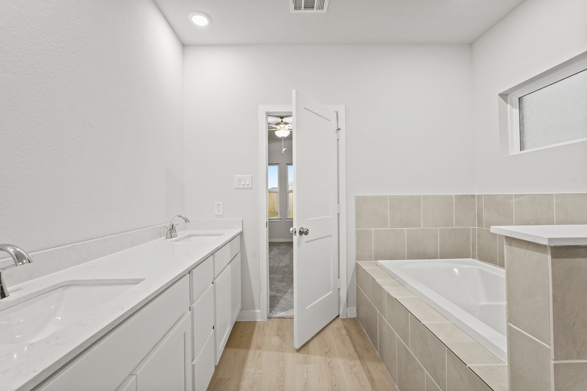 A bathroom with a tub sink and a shower.
