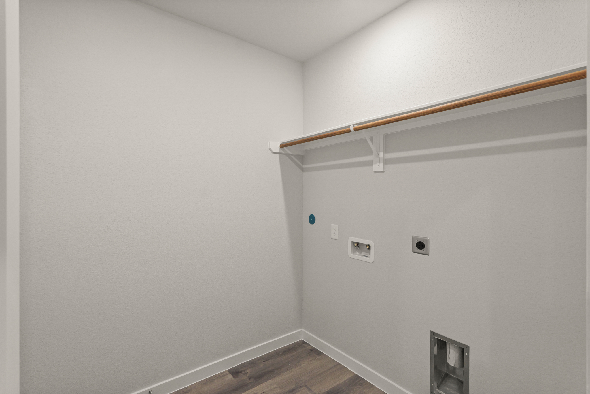 A white wall with a wood beam.