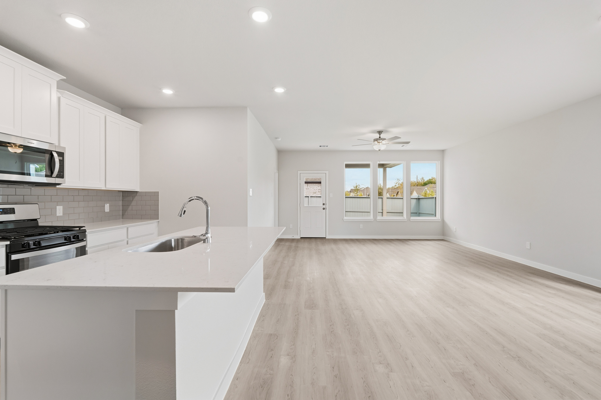 A kitchen with white cabinets.
