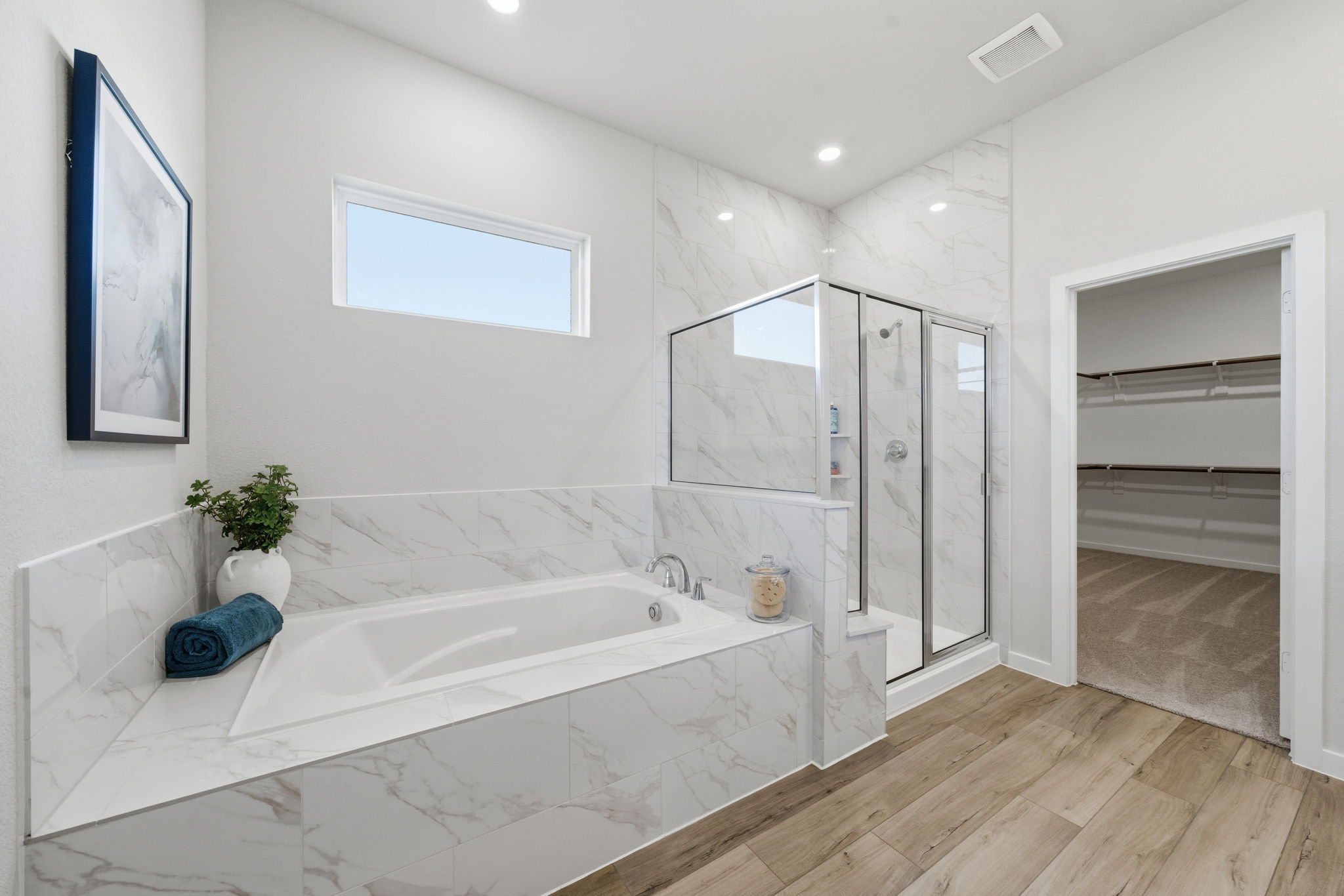 A bathroom with a tub and a mirror.