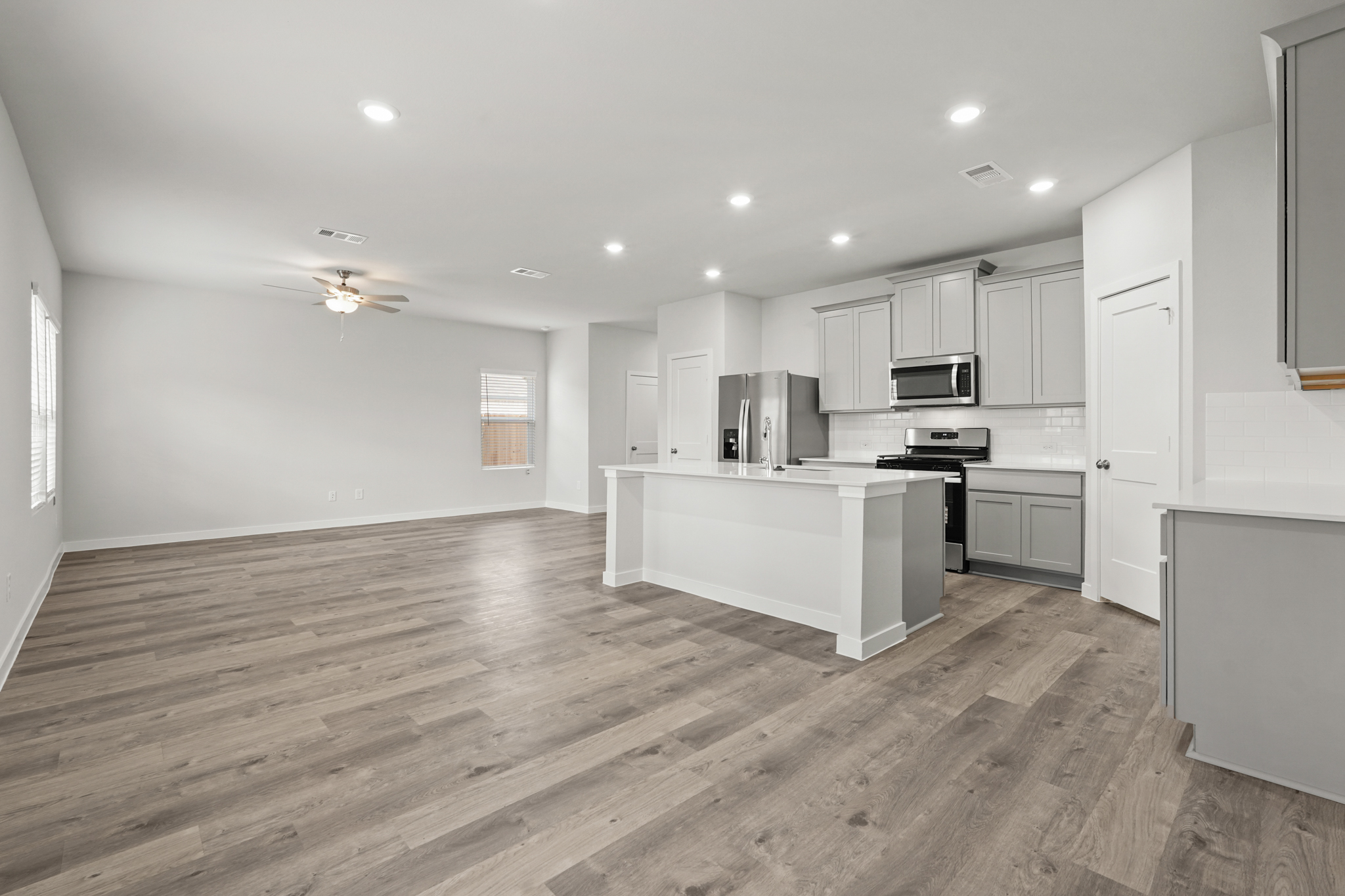 A kitchen with white cabinets.