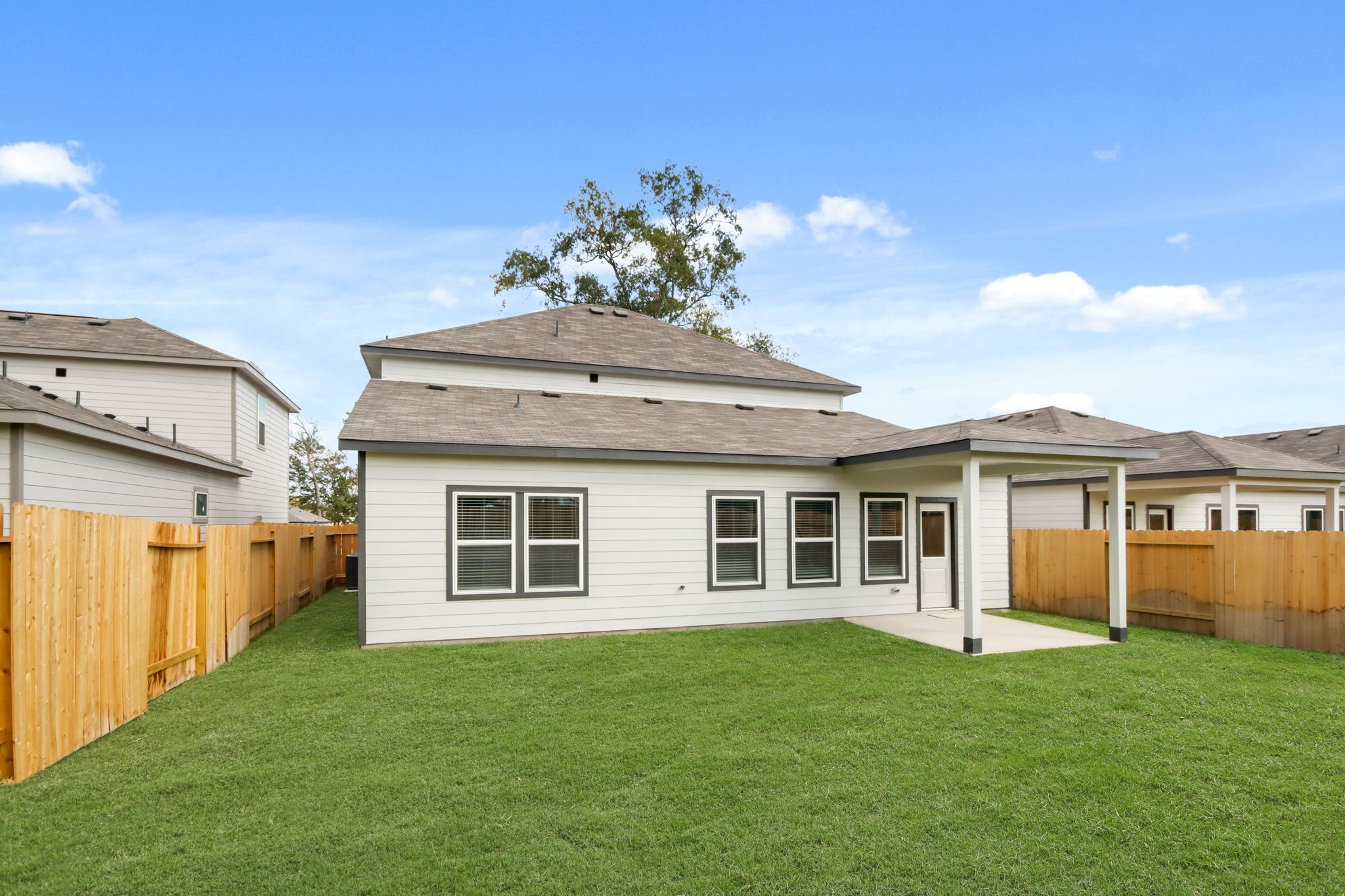 A house with a fence and grass.