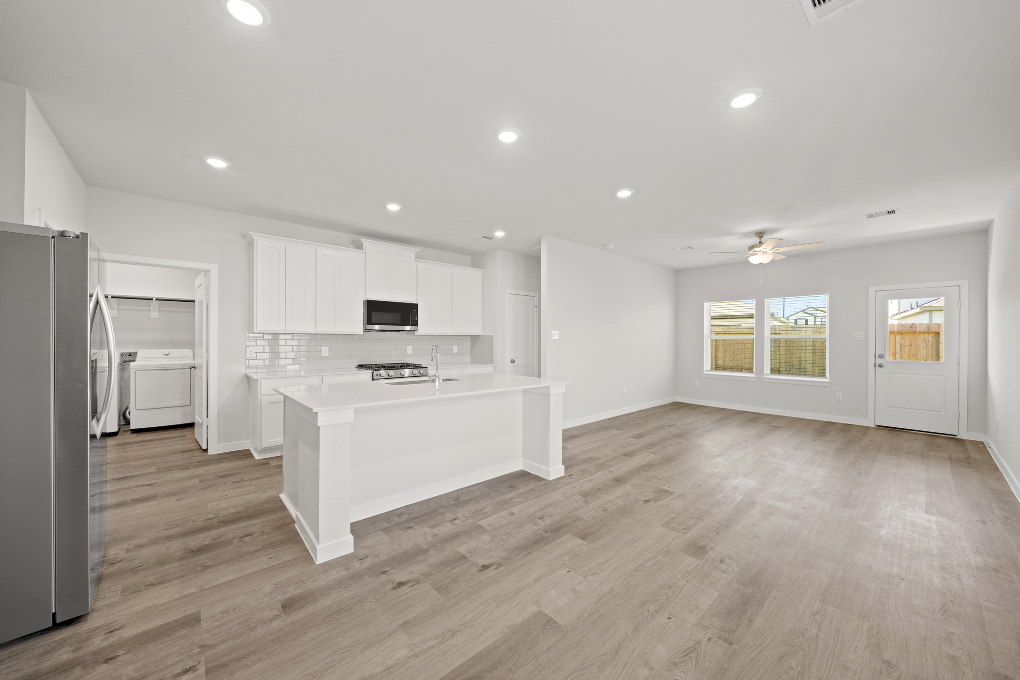 A kitchen with white cabinets.