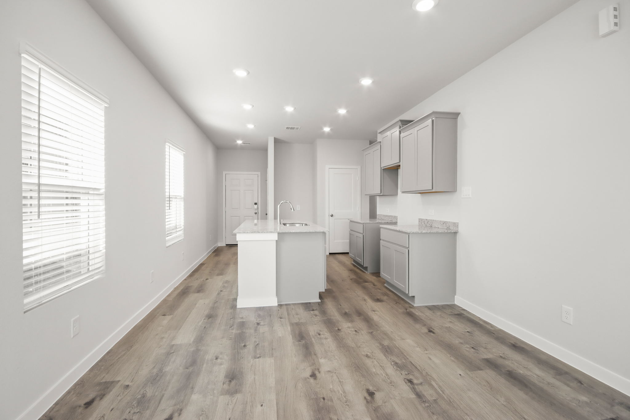 A kitchen with white cabinets.
