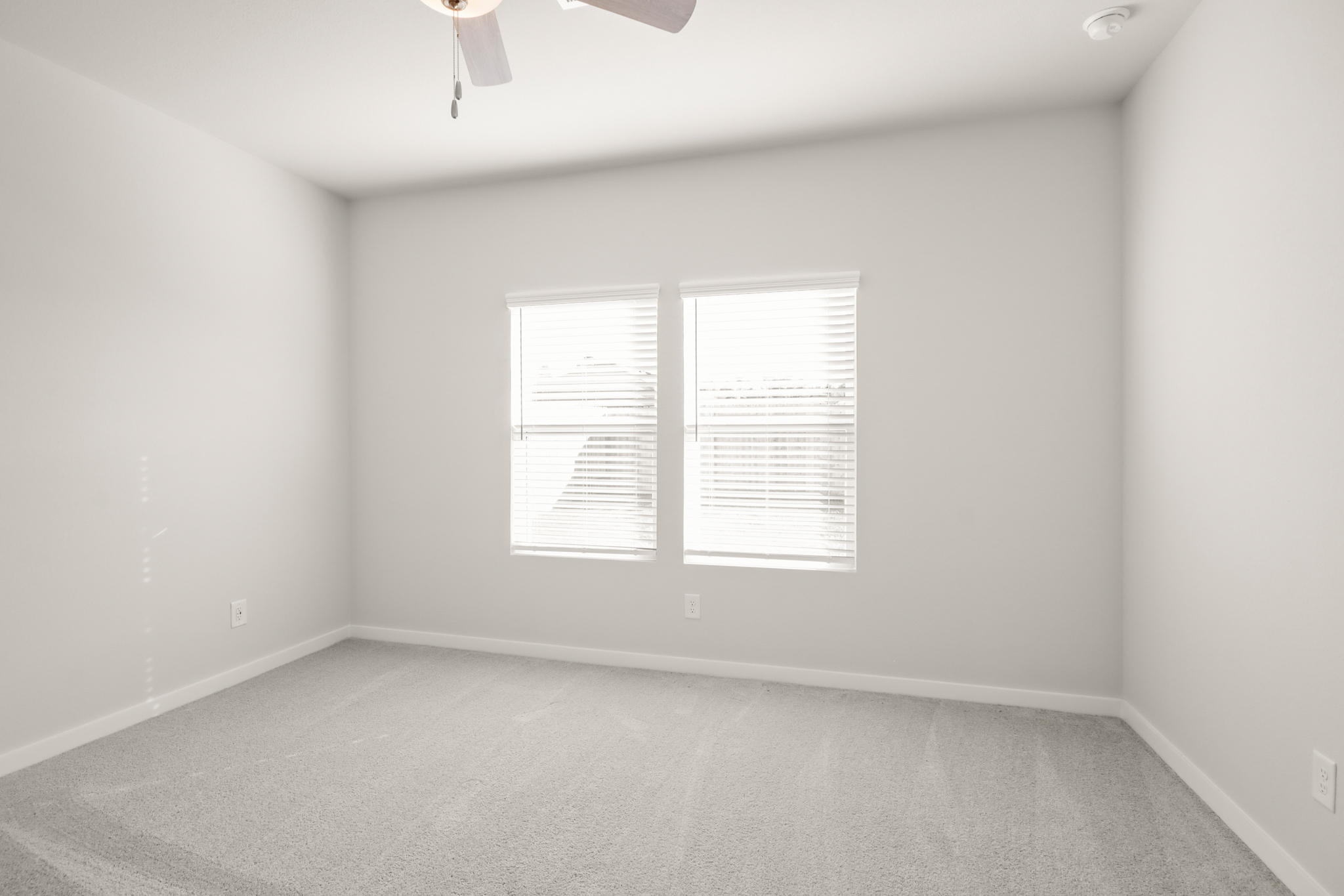 A white room with a few white doors.