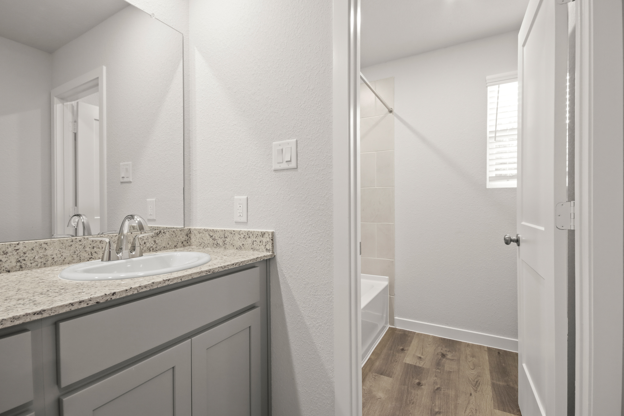 A bathroom with a sink and a shower.