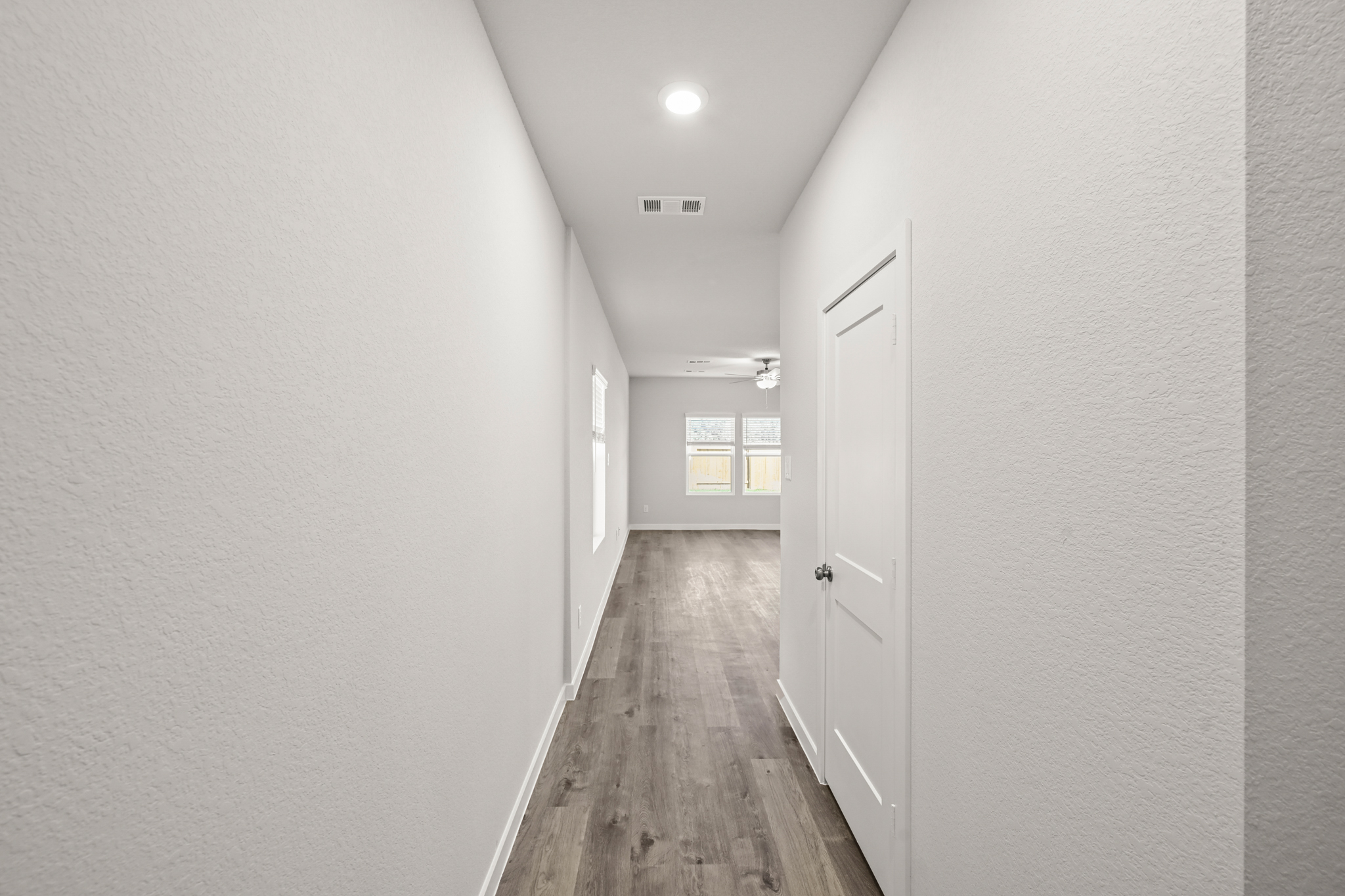 A hallway with white doors.
