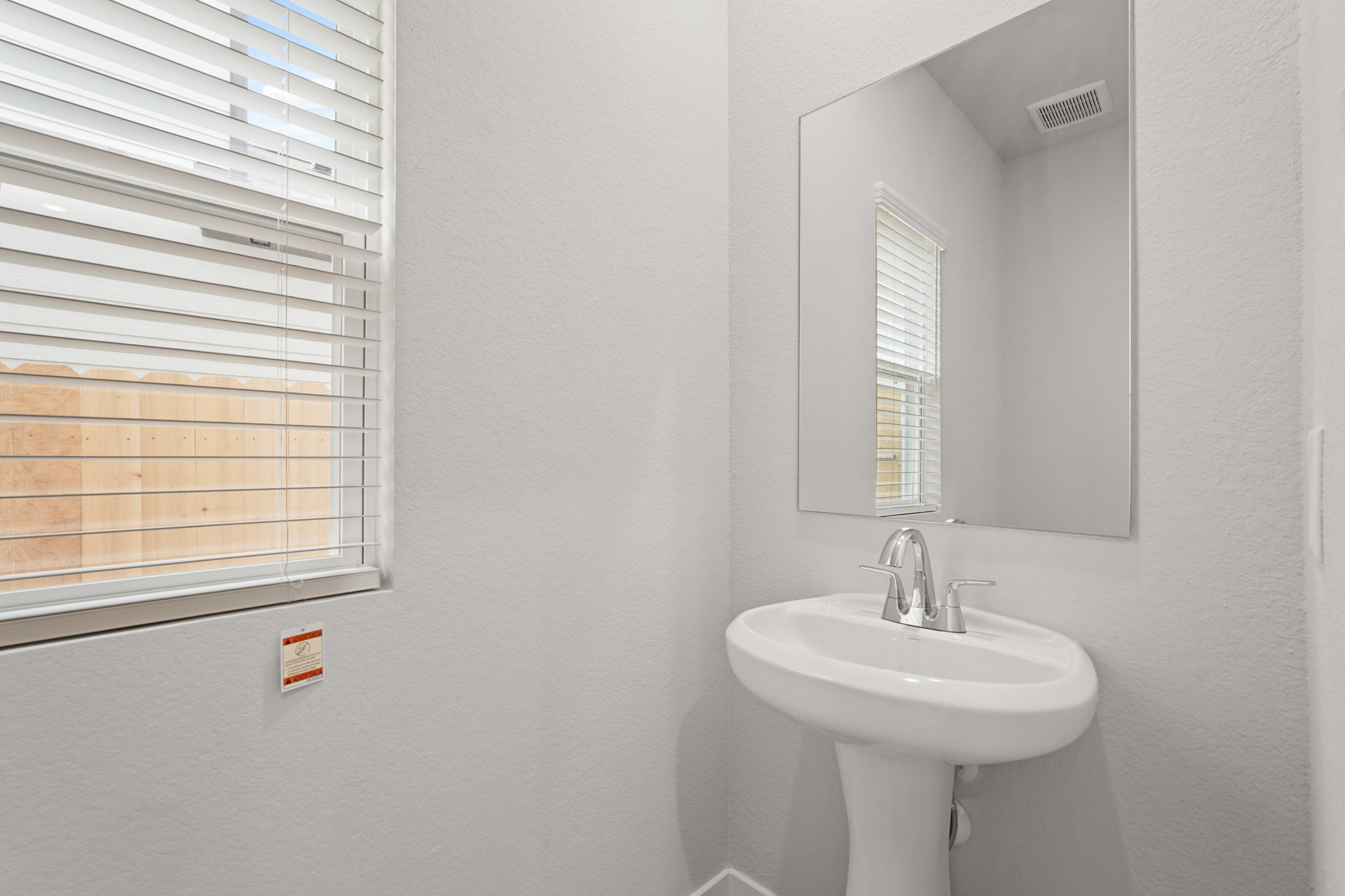 A bathroom with a mirror and sink.