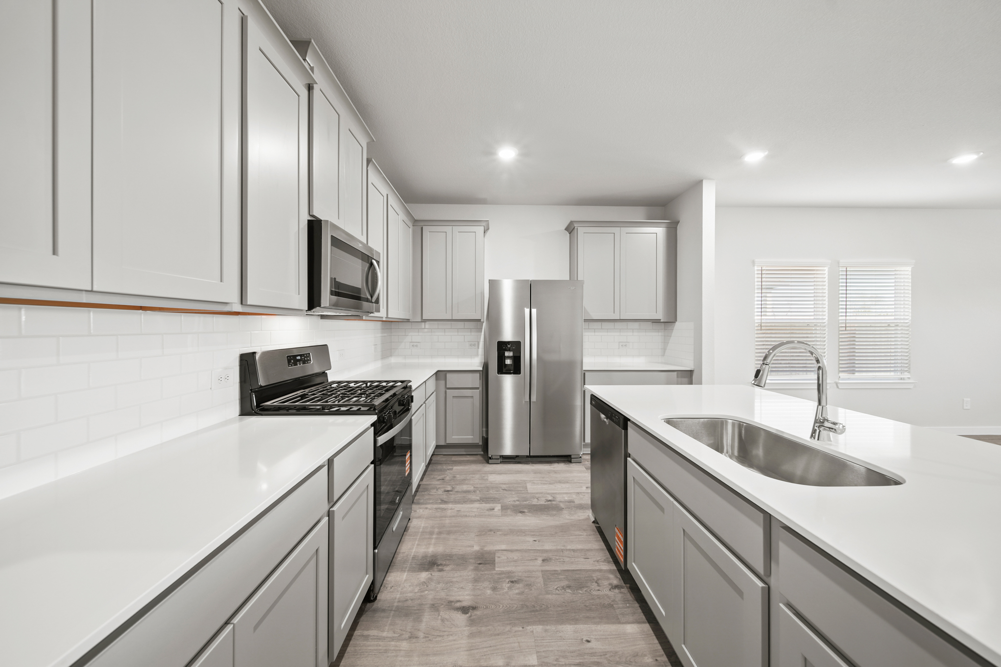 A kitchen with white cabinets.