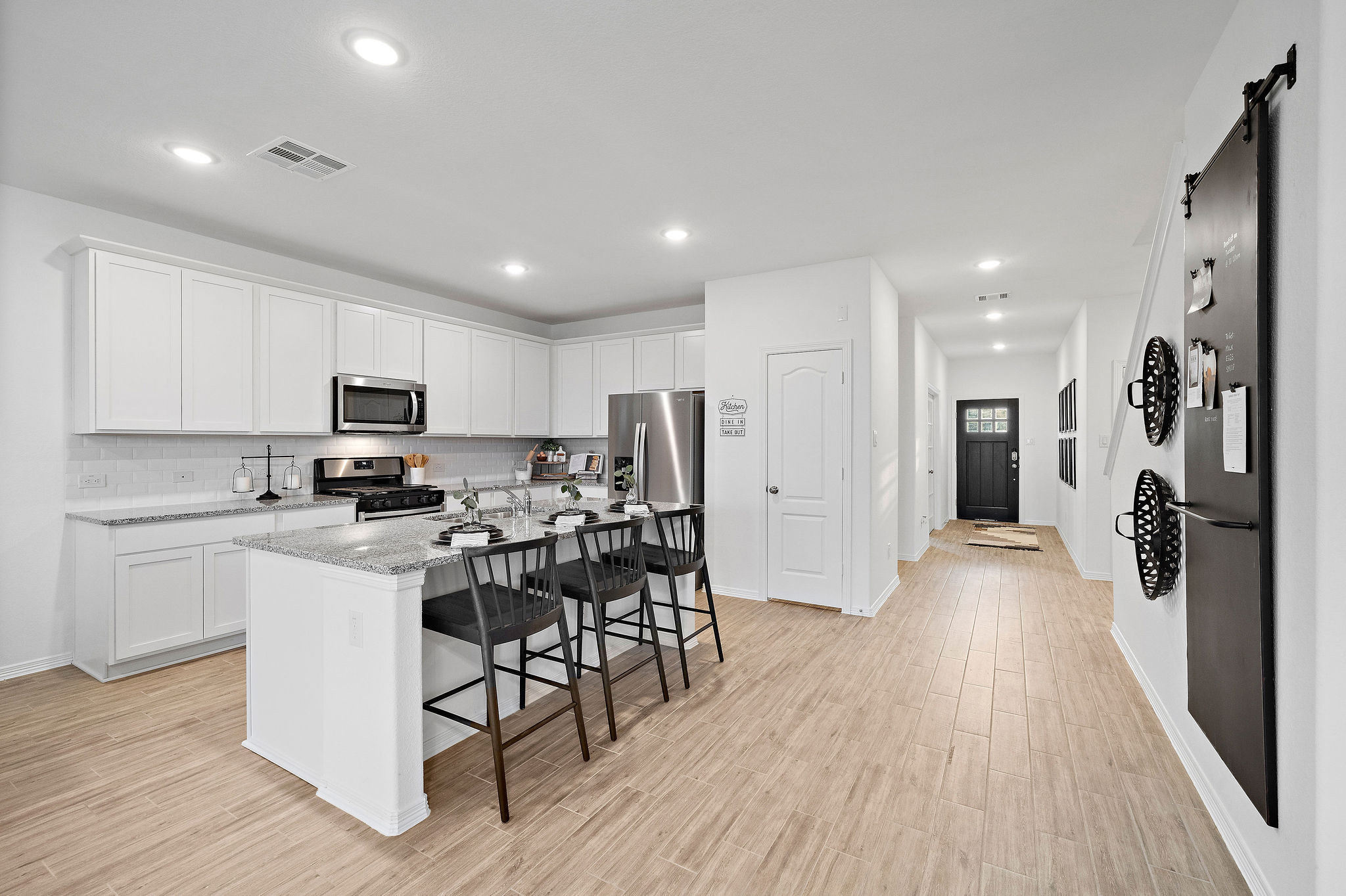 A kitchen with white cabinets.