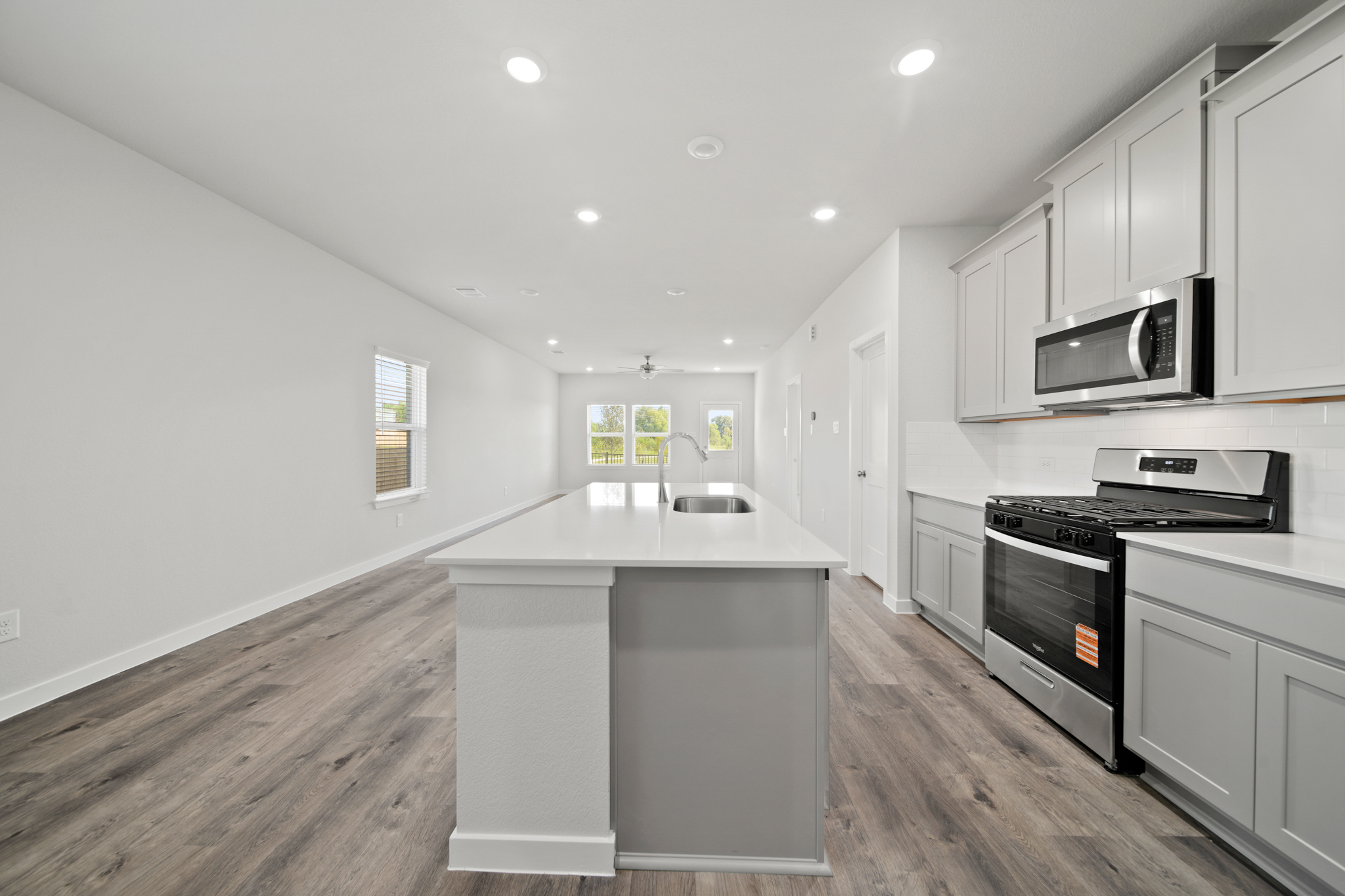 A kitchen with white cabinets.