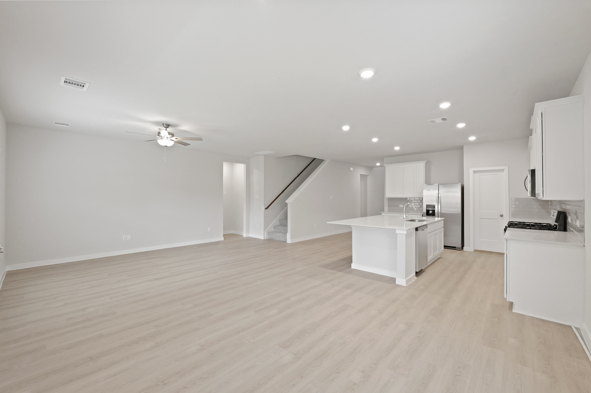A large kitchen with white cabinets.